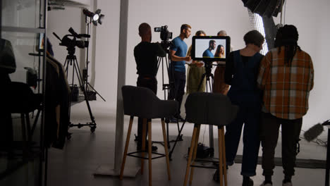 Actors-Rehearsing-With-Director-Shooting-Movie-Or-Video-In-Studio-With-Sound-And-Camera-Film-Crew